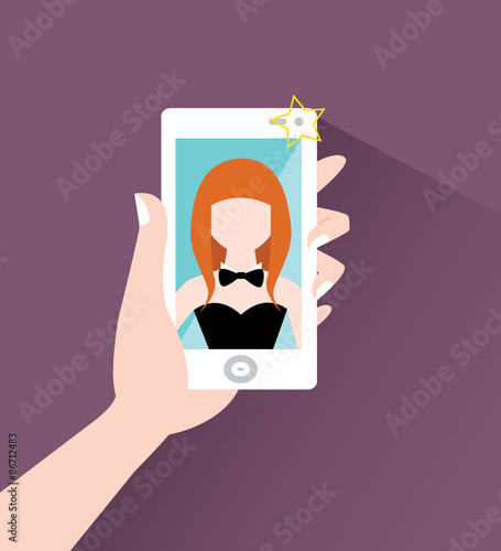 Redhead girl makes selfie on smart phone