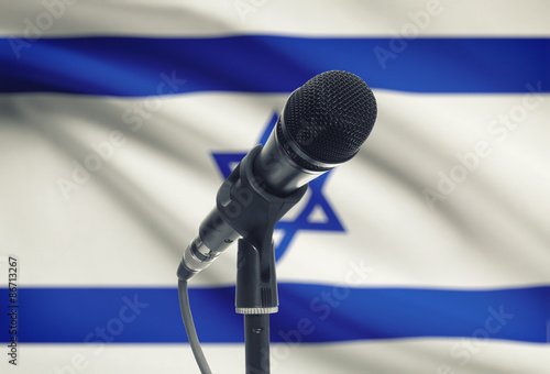 Microphone on stand with national flag on background - Israel