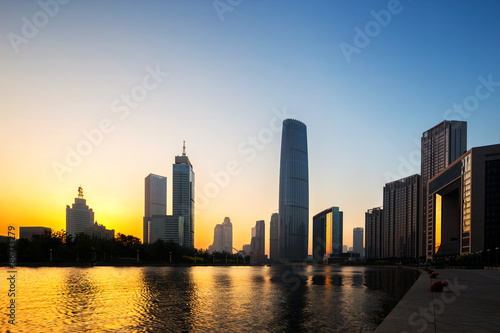 modern buildings in urban city at riverbank © zhu difeng