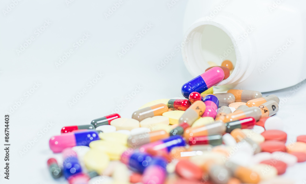 Colorful tablets, capsules in white background