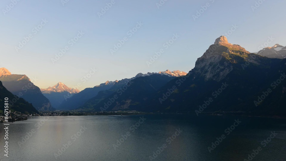 The grandiose mountain landscape with lake in central Switzerland, air view. The play of light and shadow on the mountain tops of the setting sun. The grandiose mountain landscape with lake in central Switzerland, air view. The play of light and shadow on the mountain tops of the setting sun.