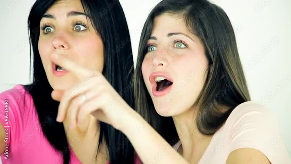 Two beautiful women laughing looking something Two beautiful women laughing looking something