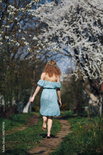 Beautiful girl follows a country road © teksomolika