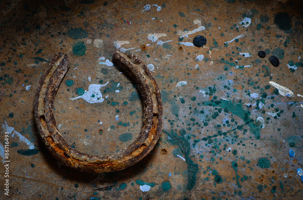 Rusty old horseshoe on a grungy background Rusty old horseshoe on a grungy background
