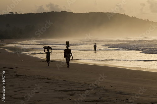 Woman and girl at sunrise. Busua Beach, Ghana