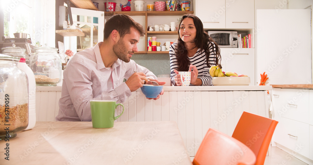 Young Couple Eating Breakfast In Kitchen Together Young Couple Eating Breakfast In Kitchen Together