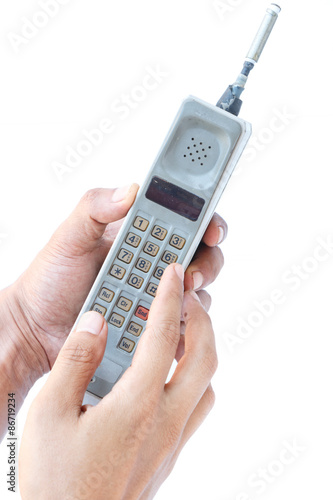 man hand holding vintage mobile phone Isolated on white background.