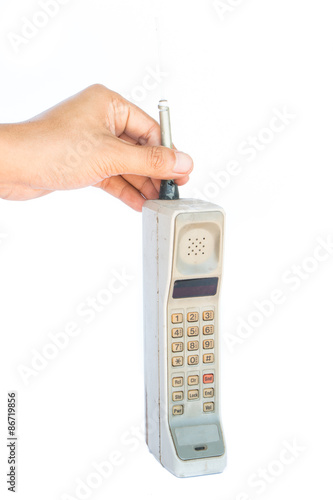 man hand holding vintage mobile phone Isolated on white background.