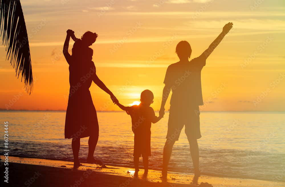 happy family with two kids having fun at sunset