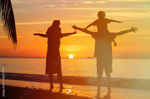 happy family with two kids having fun at sunset