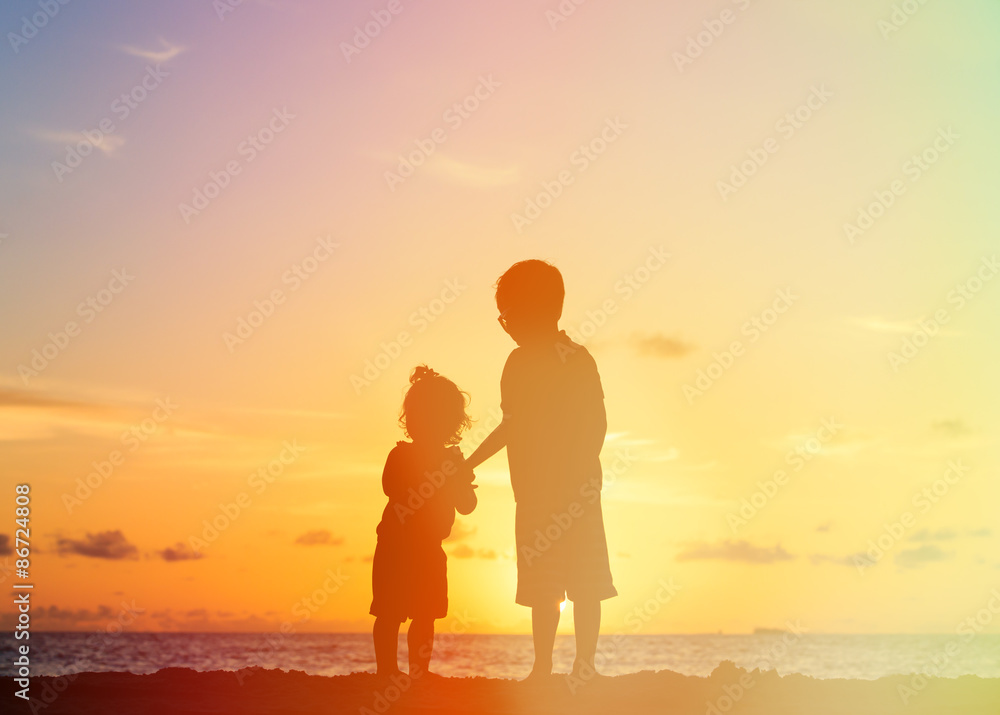 little boy and girl holding hands at sunset little boy and girl holding hands at sunset