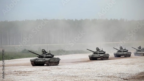 Military tanks driving along the road, Russian military convoy