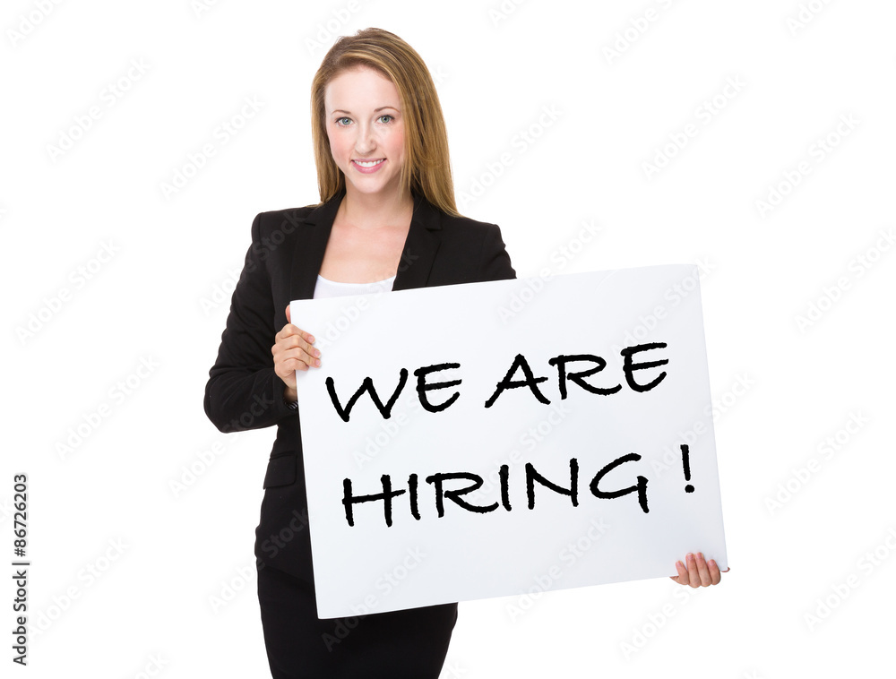 Businesswoman holding with a placard showing phrase of we are hi Businesswoman holding with a placard showing phrase of we are hi