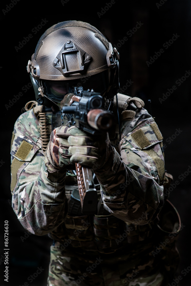Armed trooper with machine gun aiming at a target Armed trooper with machine gun aiming at a target