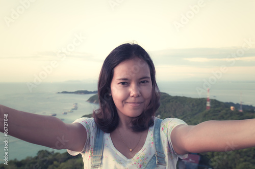 asian woman  tourist takes travel selfie at the beach in koh lar