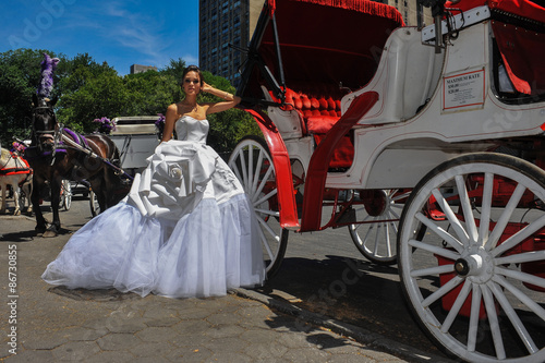 Model Kalyn Hemphill poses in front of horse carriage at the Irina Shabayeva SS 2016 Bridal collection photo shoot. photo