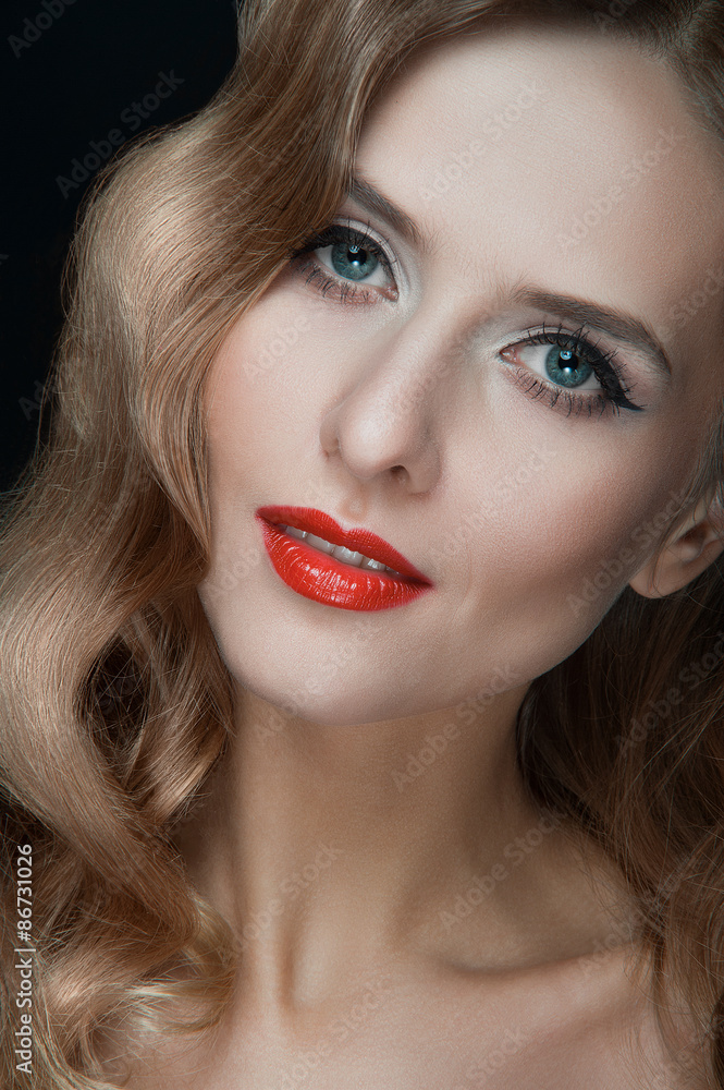 Portrait of beautiful young women with red lips, wavy hair, black eyeliner. Beauty. Studio shot. Black background. Portrait of beautiful young women with red lips, wavy hair, black eyeliner. Beauty. Studio shot. Black background.