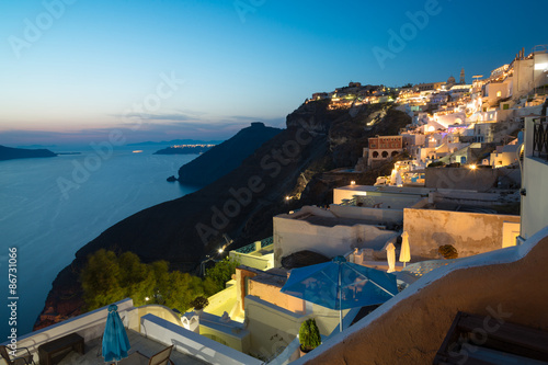 Panorama of traditional terraced houses in Fira, Santorini at dawn