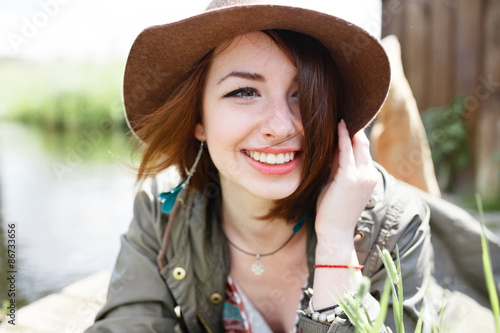 Bright stylish lifestyle portrait of pretty girl posing at hat.