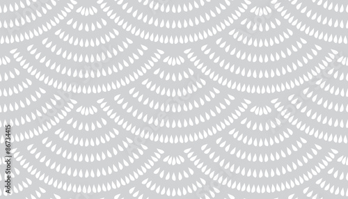 Vector seamless pattern with fish scale layout. White teardrop-shaped elements on a gray background.