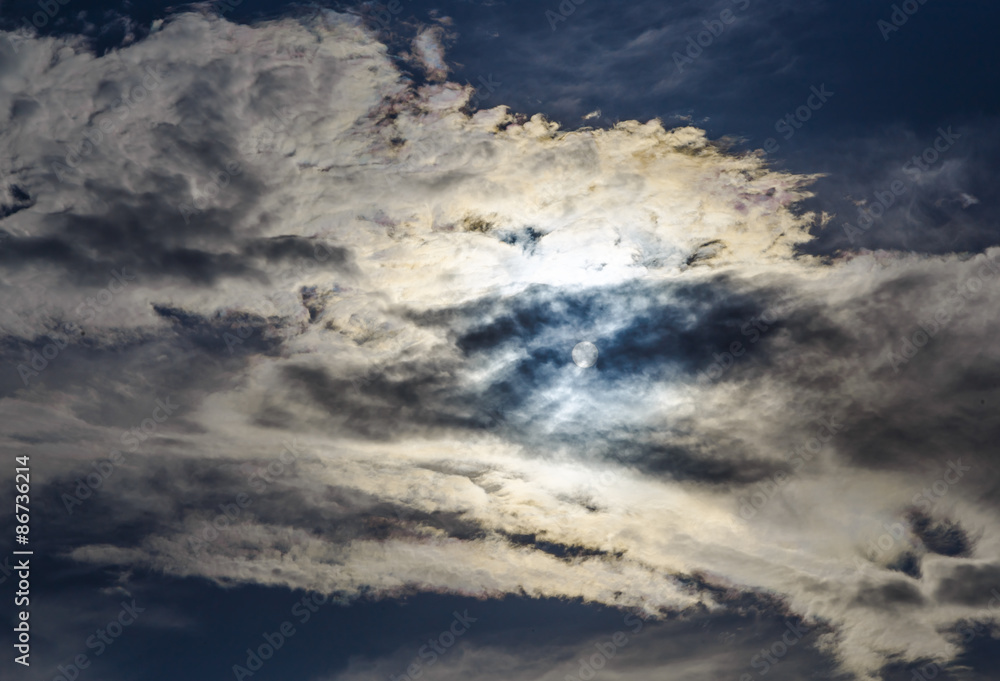 Fototapeta premium Sun is hidden behind the clouds amid a cloud of heaven
