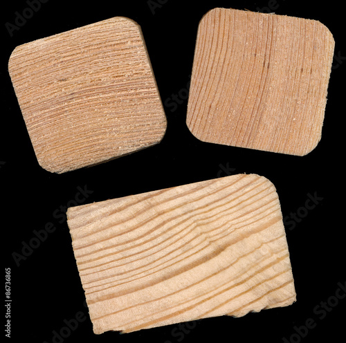 Isolated pine bricks against a black background photo