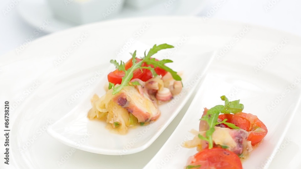appetizer buffet style octopus, tomatoes, arugula, onion, cheese appetizer buffet style octopus, tomatoes, arugula, onion, cheese