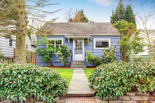 Authentic blue house with lots of greenery.