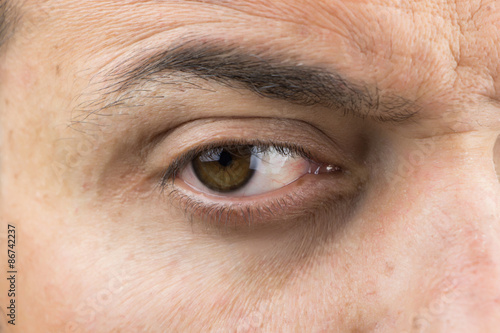Upper part of males face closeup on eye © okolaa