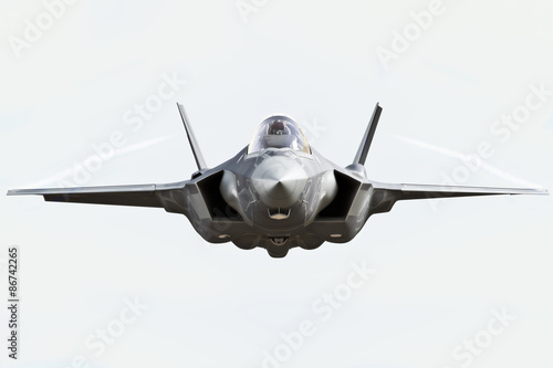 F35 front view close up flying to the camera with chem trails photo