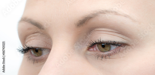 Upper part of females face closeup on eyes looking down