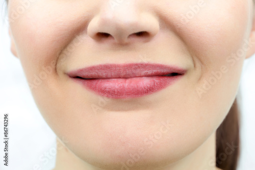 Closeup on mouth of females smiling face