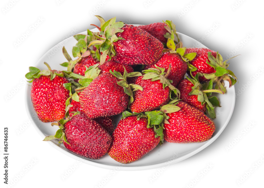 Front and top pile of fresh strawberries on white plate Front and top pile of fresh strawberries on white plate