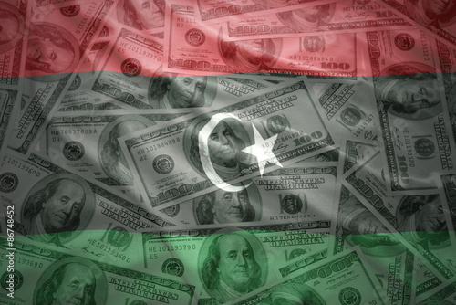 colorful waving libyan flag on a american dollar money background