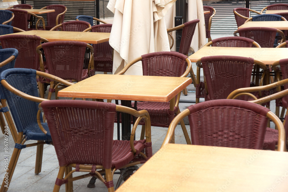 Tables and chairs in cafe on street 