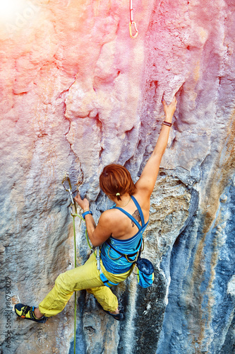 Fototapeta Naklejka Na Ścianę i Meble -  Rock climber climbing up a cliff