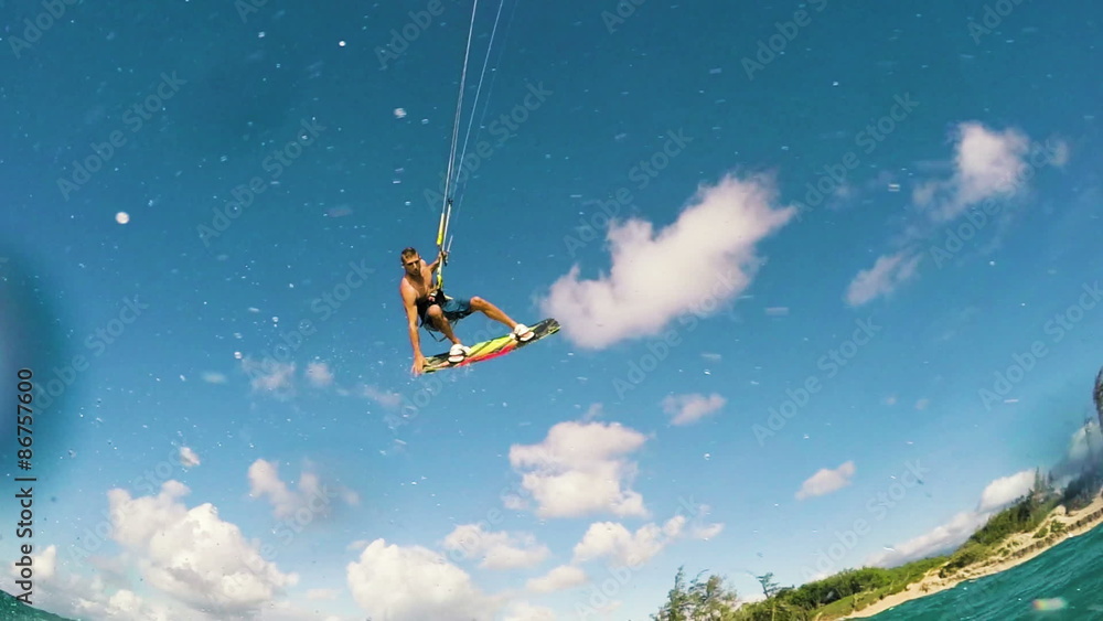 Young Man Kite Boarding in Ocean. Extreme Summer Sport in Slow Motion. Young Man Kite Boarding in Ocean. Extreme Summer Sport in Slow Motion.