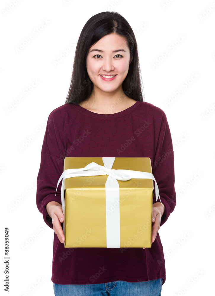 Woman showing a big golden giftbox Woman showing a big golden giftbox