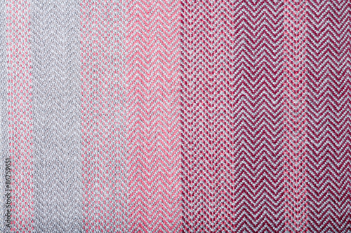 Handmade fabric with pink and gray striped texture. Clothes background