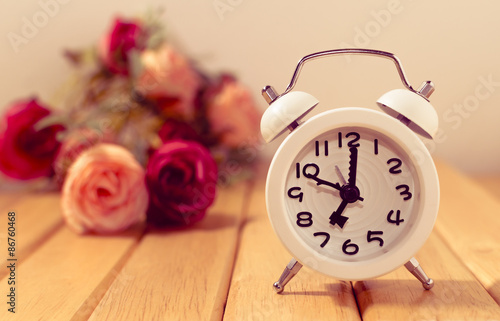 alarm clock on table with vintage retro effect