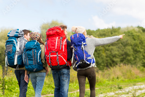 group of friends with backpacks hiking