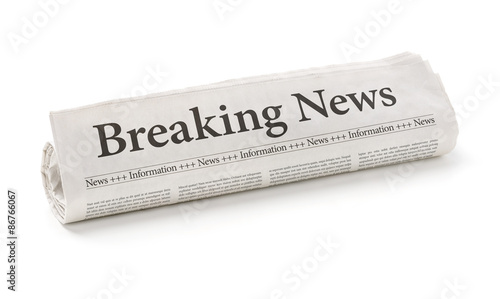 Photos Rolled newspaper with the headline Breaking news