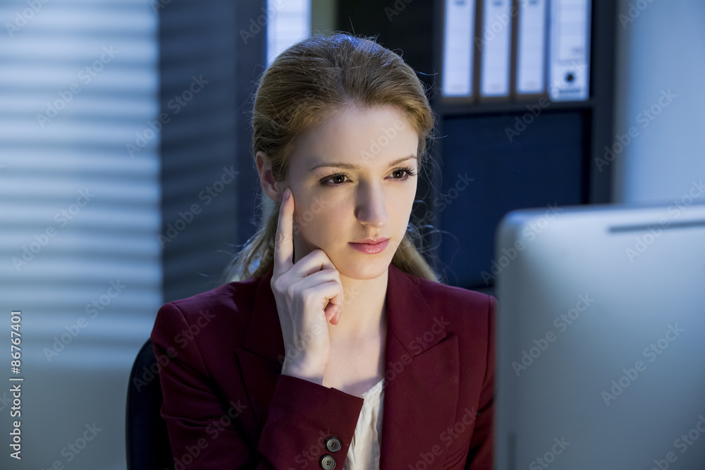 Business woman working at the computer late at night in the office. Looking stressful. Having Headache. Business woman working at the computer late at night in the office. Looking stressful. Having Headache.