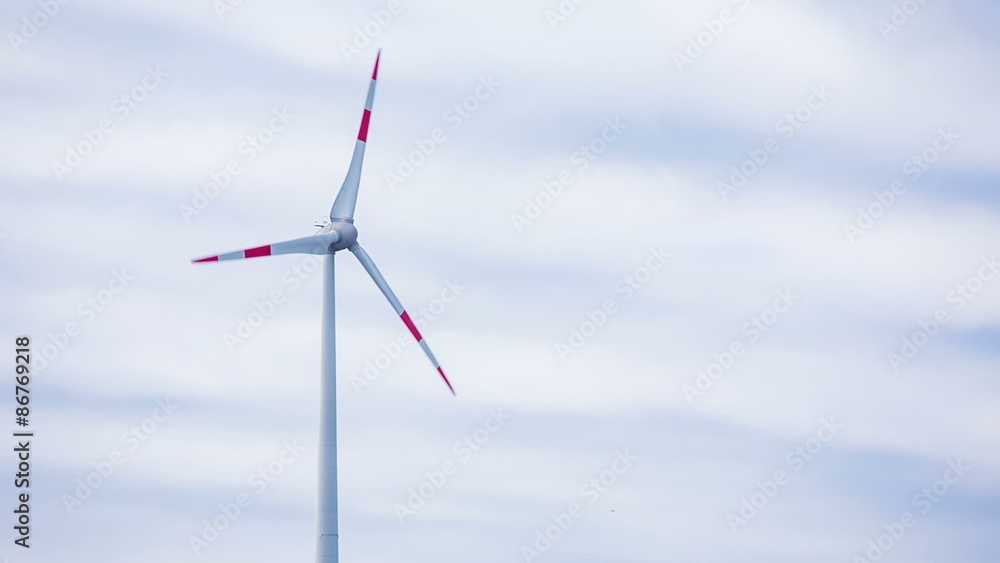 Turning wind turbine on cloudy day Turning wind turbine on cloudy day