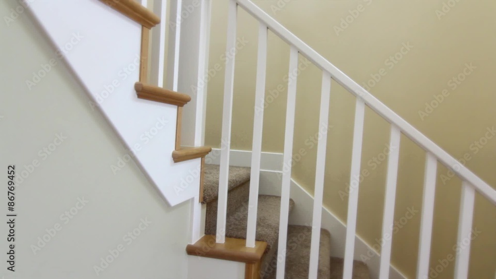 a jib shot of a stairwell in a front entry a jib shot of a stairwell in a front entry