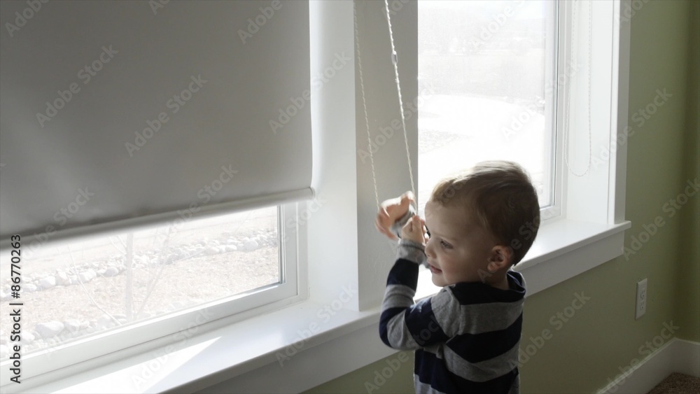 Toddler opening his window blind Toddler opening his window blind