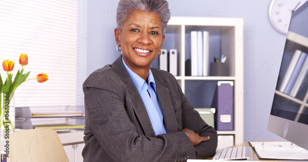 © Mark Adams - Mature African businesswoman sitting at desk