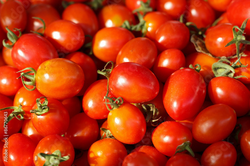Group of fresh tomatoes in basket.