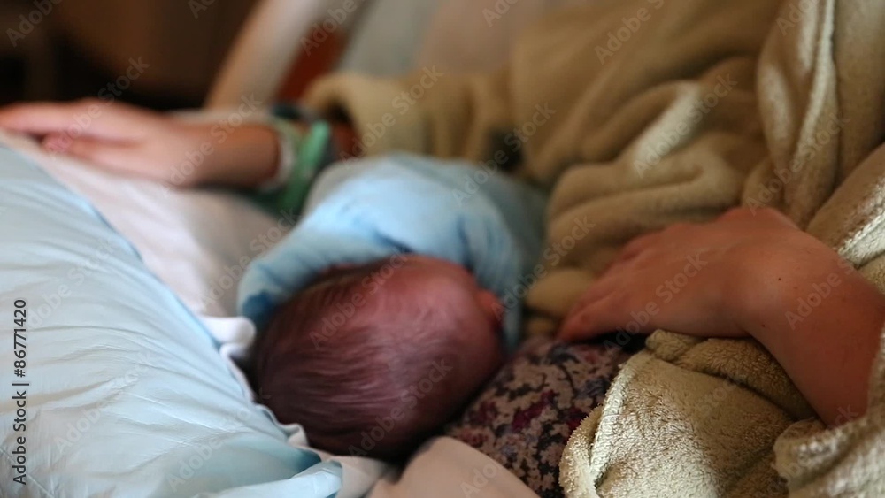 the mother and cute newborn in hospital bed dolly shot the mother and cute newborn in hospital bed dolly shot
