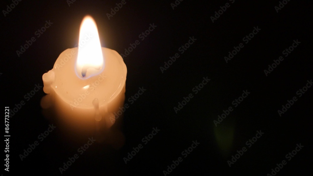 Blowing out a lit candle in a dark room Blowing out a lit candle in a dark room